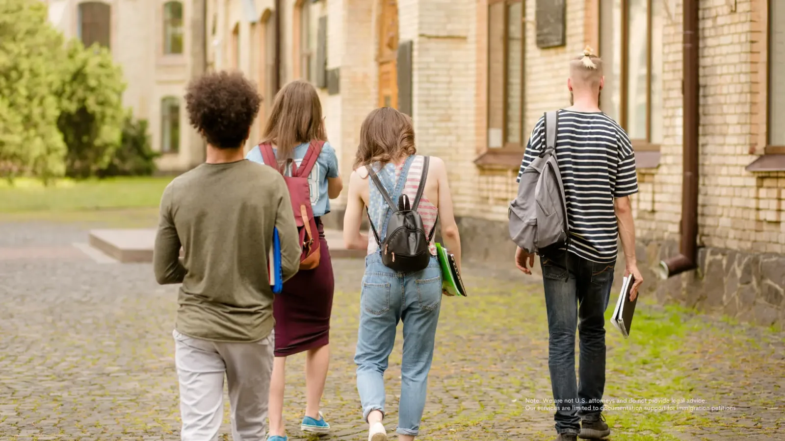 F-1 students walking across a college campus with backpacks and books